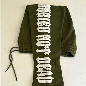 Revenant Olive Green Sweatpants with White Graphic.  Size Medium